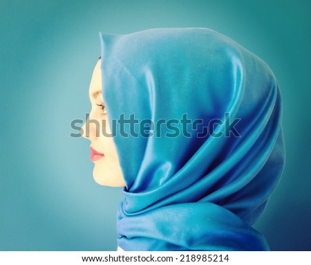 Beautiful Middle eastern girl with a scarf on red and blue, retro colorized
