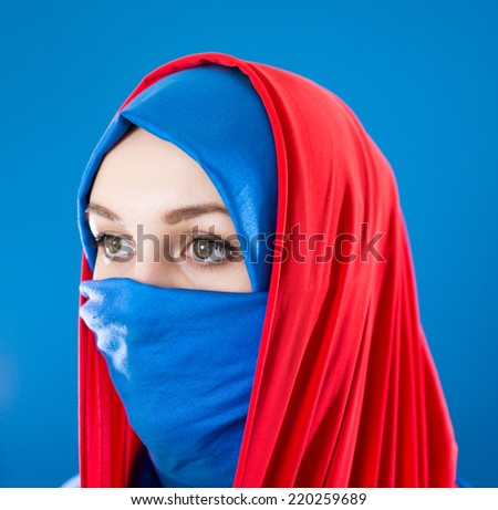 Beautiful Middle eastern girl with a veil on red and blue