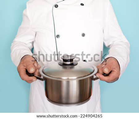 Elderly chef in white cook uniform