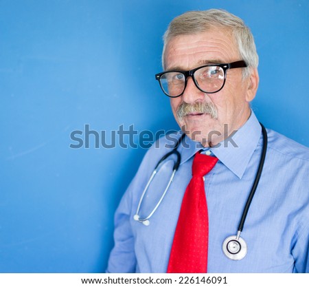 Male doctor on blue lab background