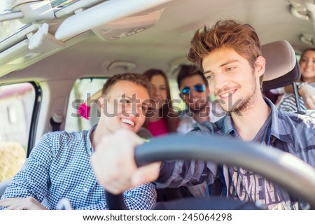 Young people having vacation enjoying fun driving car