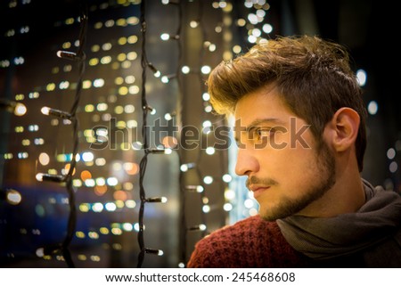 Handsome man alone in the restaurant at night
