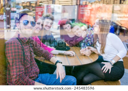 Double exposure of young people enjoying and having fun (image taken mostly behind glass reflection for desired look)