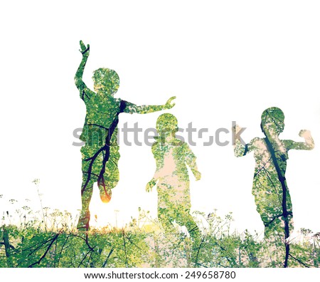 Children running on meadow at sunset