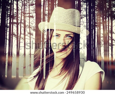 Double exposure effect of beautiful young brunette woman with a hat