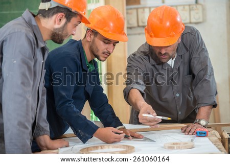 Teamwork on project in factory
