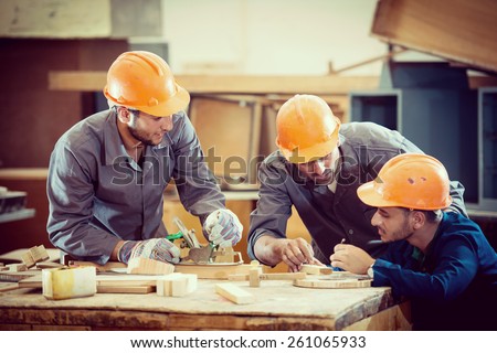 Team working on project in industrial wood factory