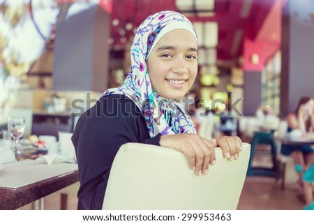 Happy Muslim family in restaurant