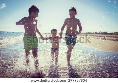 Fun kids playing splash at beach