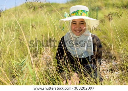 Happy Arabic Muslim girl in beautiful nature