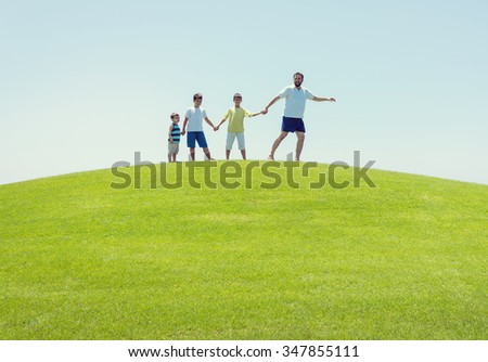 Happy summer vacation for family on green meadow near sea