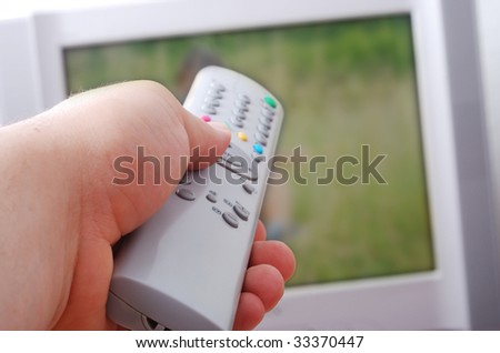 Remote control used by adult man in his hand