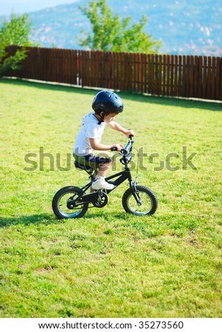 Childhood activity with bike on green meadow