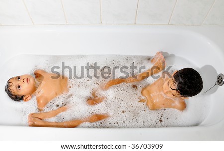 Two male children playing and taking a bath together