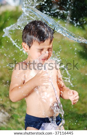 Very cute child playing with water outdoor