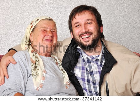An old woman with good funny face and young man beside