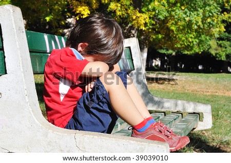 Sad child in the park, outdoor, summer to fall
