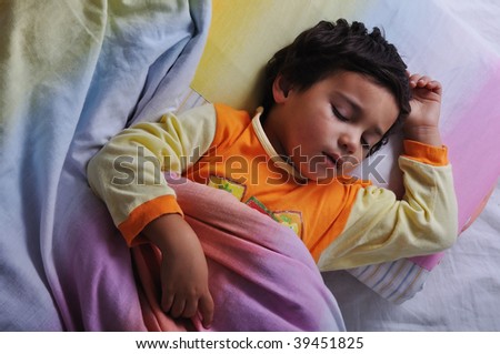 Child asleep, in bed, dark