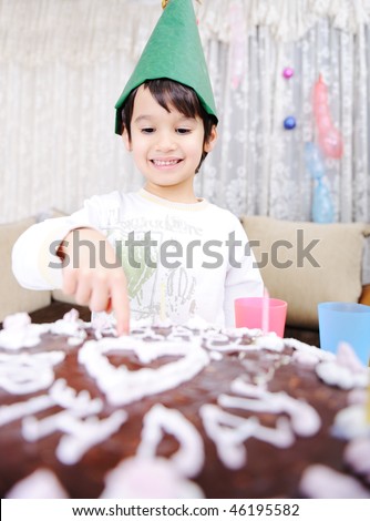 Kid on cake: happy birthday on