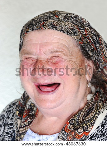 Elderly person, portrait in natural pose laughing