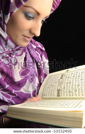 stock photo : Beautiful Muslim girl reading holy book Koran, closeup