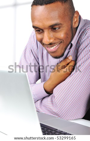 Young nice black man on laptop