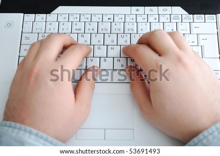 man typing on a computer keyboard
