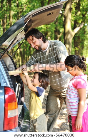 Family with car in nature
