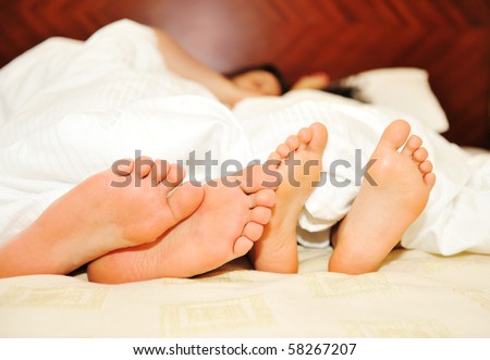 Lovely couple in bed, focus on feet
