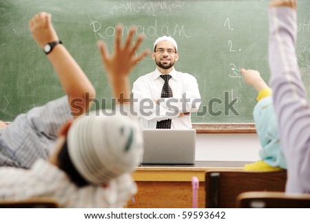 Good teacher in classroom in front of the board
