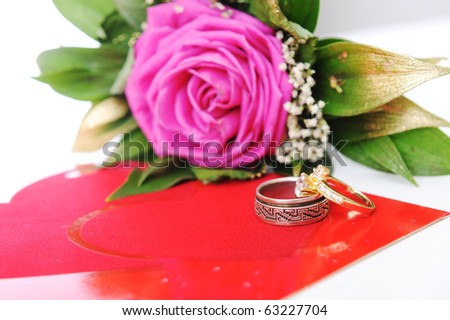 Love rose, for lover, on white with affiance (marriage) rings and red heart card