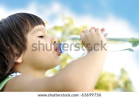 Child drinking pure water in nature