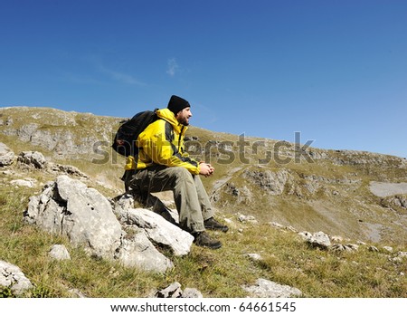 Man sitting on top of mountain