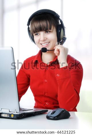 A friendly secretary/telephone operator in an office environment.