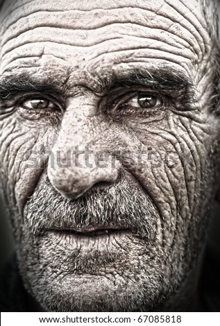 Very old face - very old photo. Portrait, elderly man with huge wrinkles on face. Some grain added.
