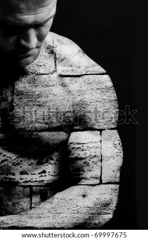 Strong man with a helthy body, strong as a rock, skin and body are like the rock stones. Conceptual background.