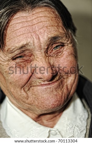 Closeup portrait of elderly happy woman smiling, age between 60 and 70