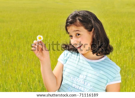 Happy girl  with white flower smiling outdoor