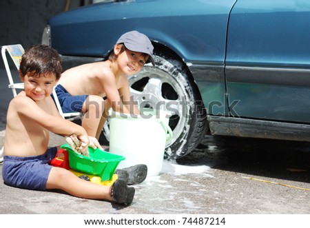 Playing around the car and cleaning, children in summertime