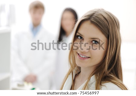 group of scientists working at the laboratory, young beauty female researcher in the front