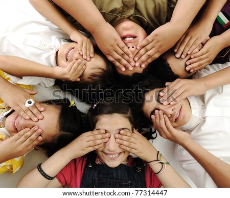 happy children group  lying and closing eyes by hands