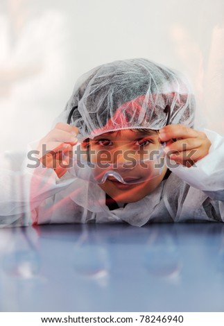 Smart cute little male child  experimenting with test tubes in real modern hospital lab