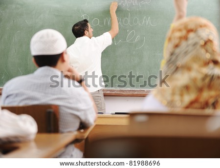 Muslim arabic teacher writing on board