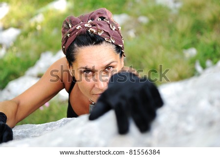 Female climbing the rock on mountain
