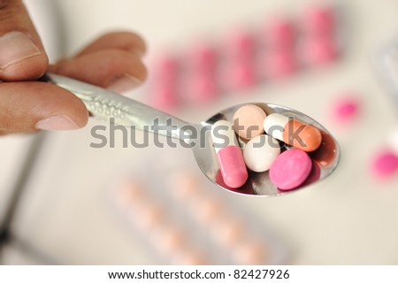 Doctor with pills in spoon