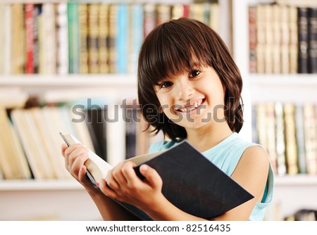 Kid with book in library