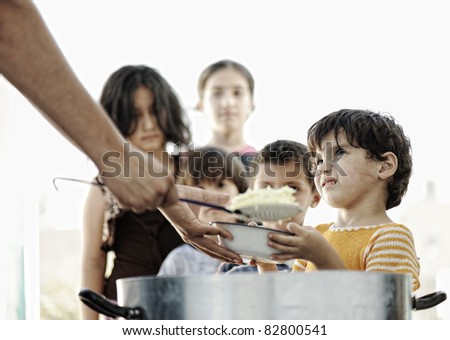 Hungry children in refugee camp, distribution of humanitarian food