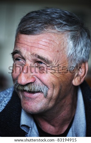 Common elderly positive man with mustache, happy smiling