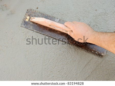 Concrete leveling, worker\'s hand