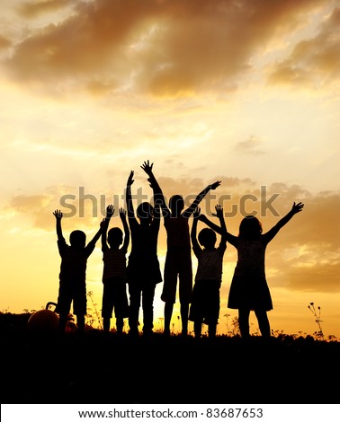 Happy children on meadow, sunset, copy space above